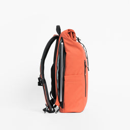 Side view of The Roll Top 15L in Ember Orange with laptop compartment