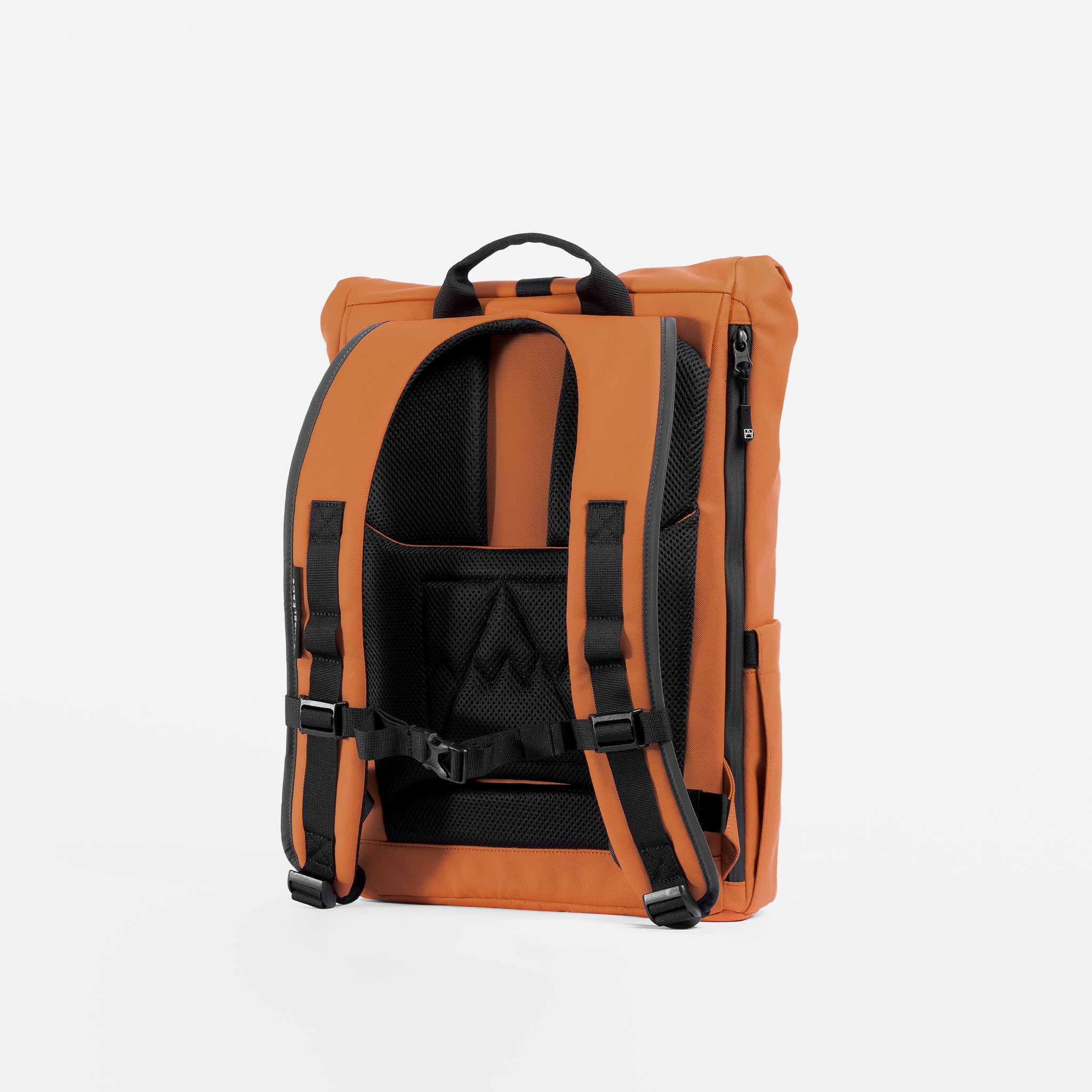 A studio shot of the back panel and adjustable chest straps on the Rust Roll Top 15L