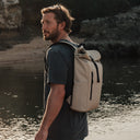 Man wearing The Roll Top 15L in Sand on a beach