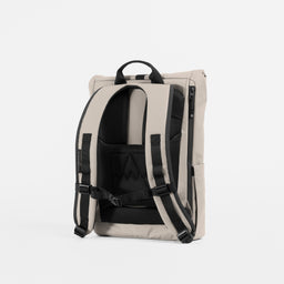A studio shot of the back panel and adjustable chest straps on the Roll Top 15L in Sand