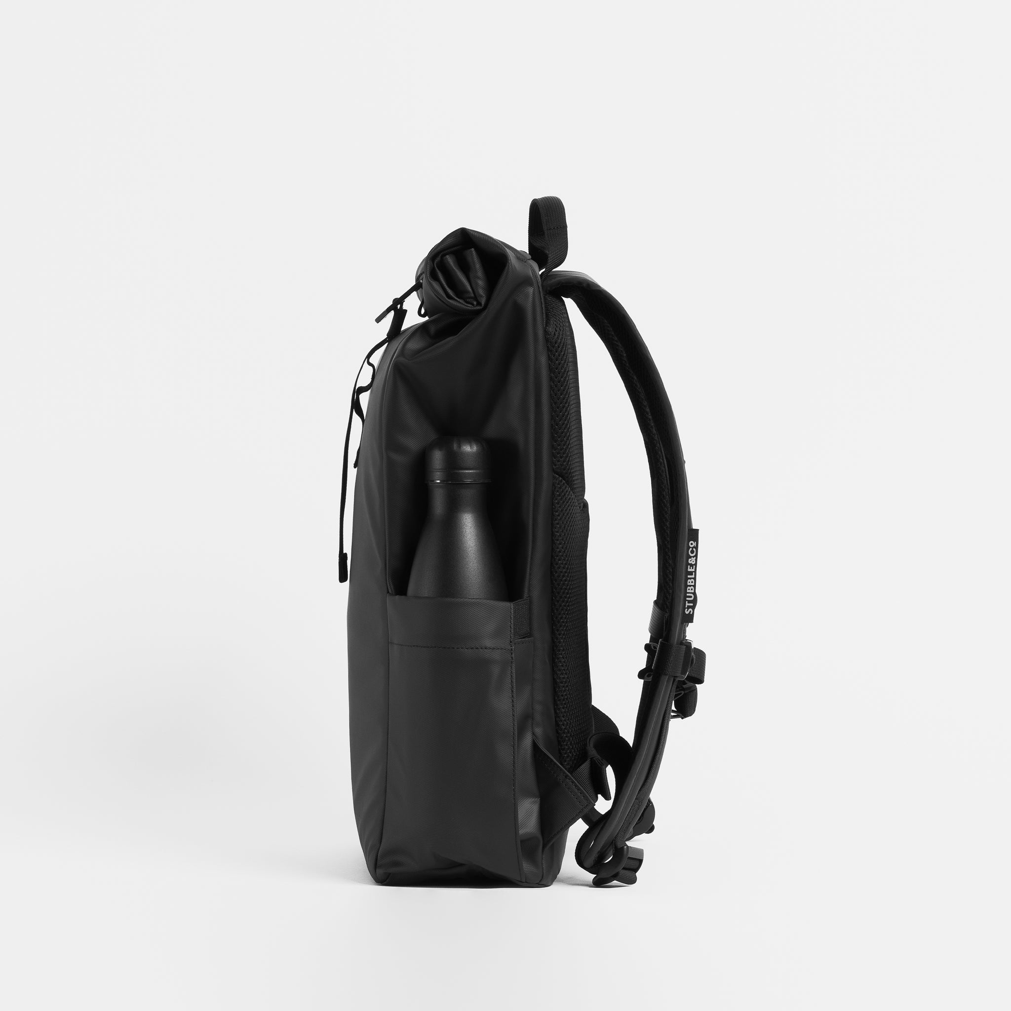 Side product shot of The Roll Top 15L in All Black with a water bottle in the side pocket.