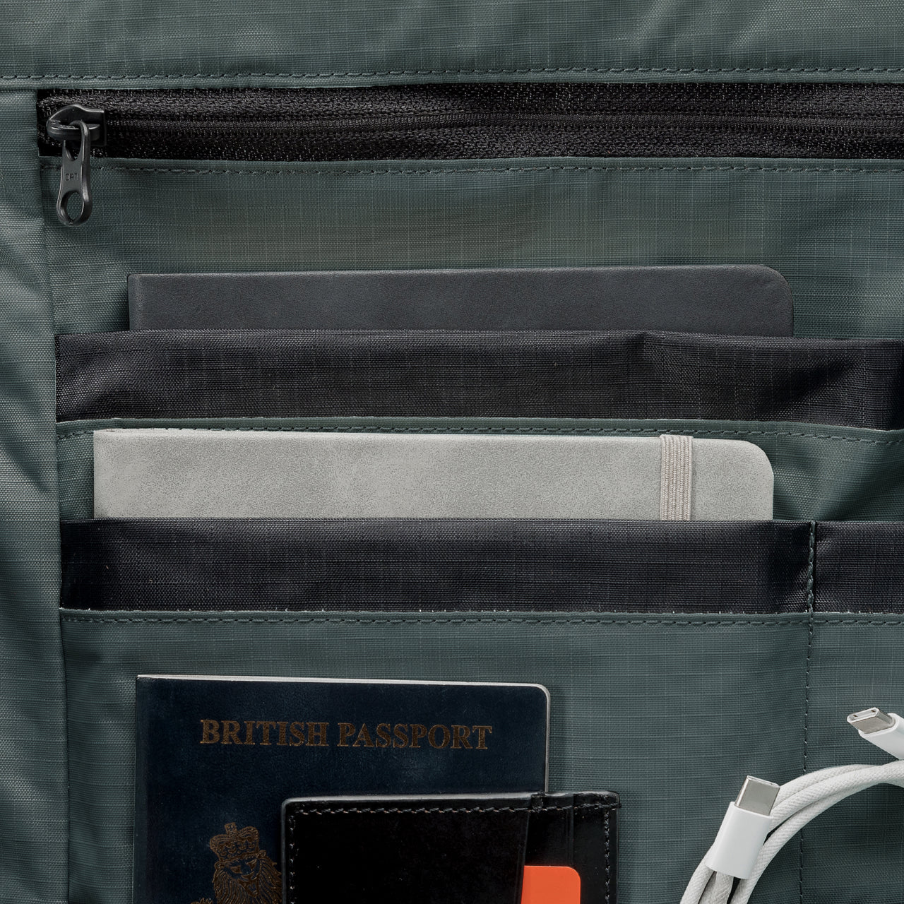 A studio shot of the interior organisation and dark pearl lining within the Roll Top 15L in Tonal Sand