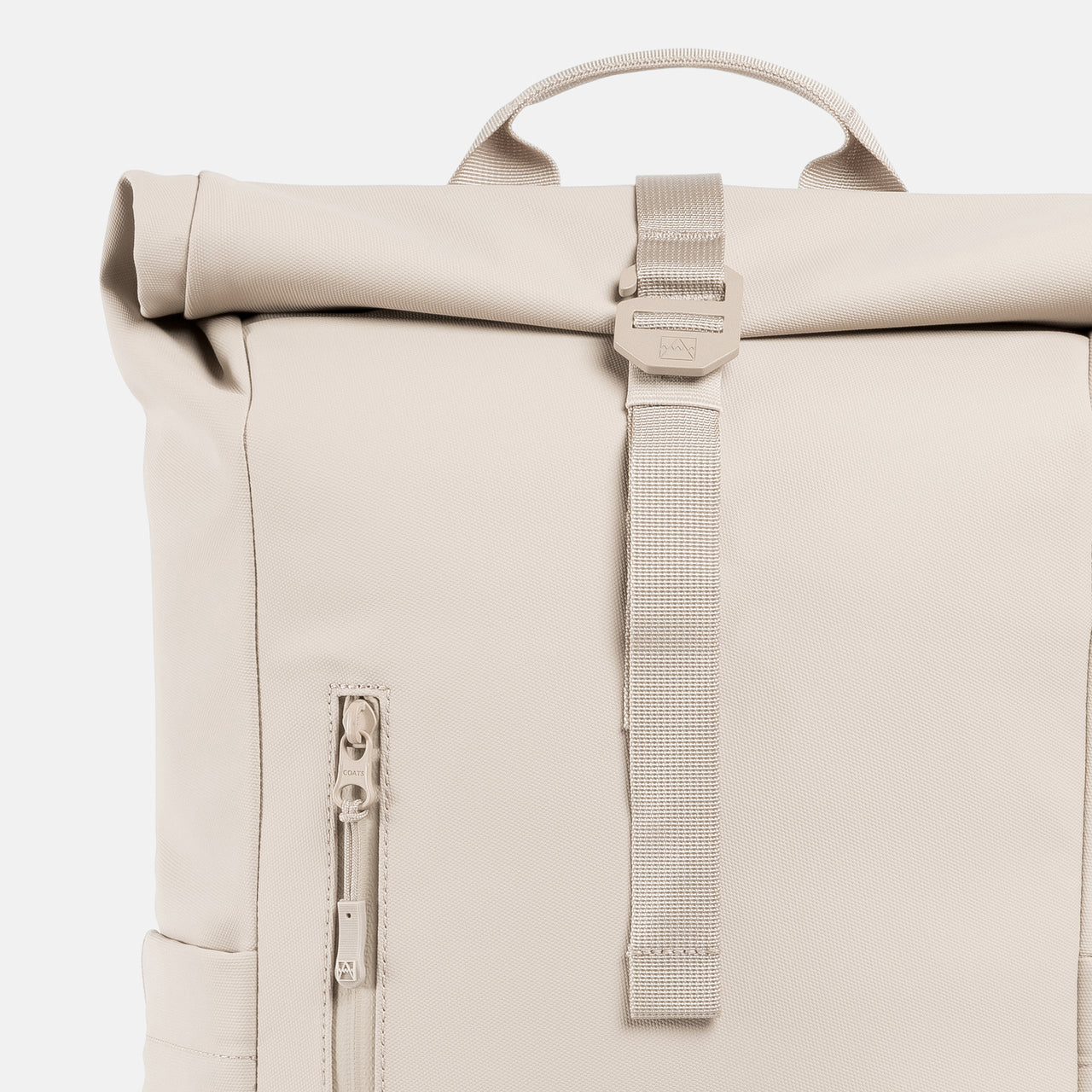 A studio shot of the close up of the g-hook and roll on the Roll Top 15L in Tonal Sand