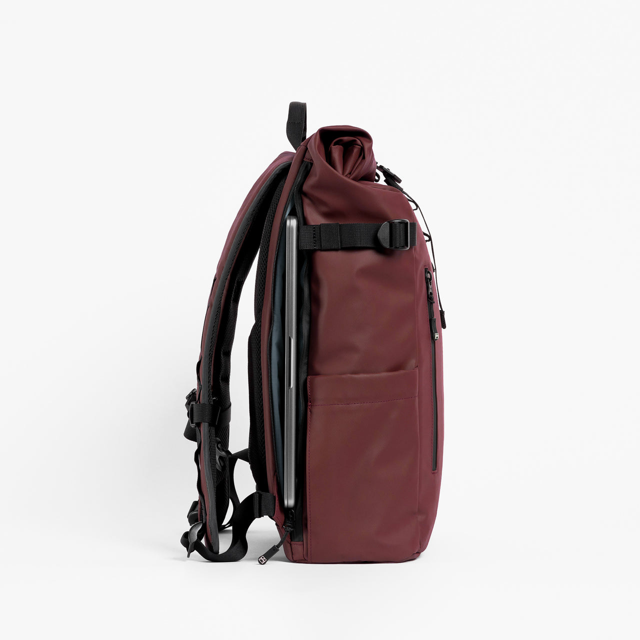 A studio shot of the laptop pocket on the Roll Top 20L in Garnet Red
