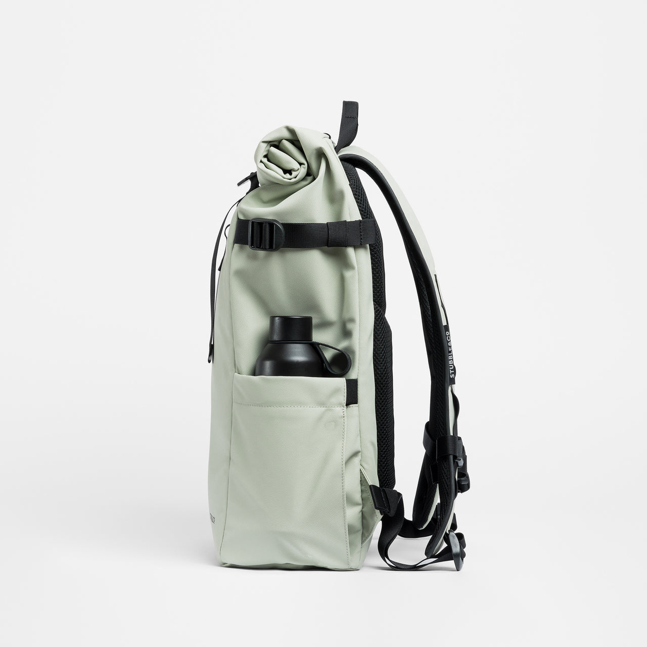 A studio shot of the bottle in the pocket of a Roll Top 20L in Soft Mint