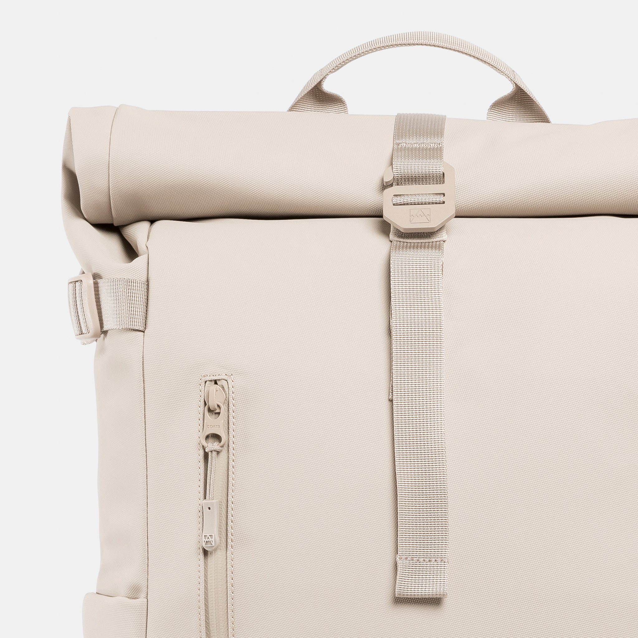 A close up of the g-hook and roll on the Roll Top 20L in Tonal Sand