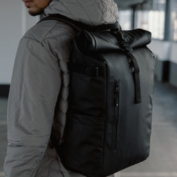 Close-up of The Roll Top 20L in All Black on a man's back