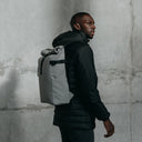 Man wearing The Roll Top 20L in Concrete