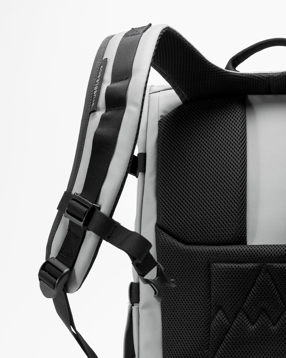 a studio shot of a concrete roll top 20l showing a close up of the upgraded fully adjustable chest straps