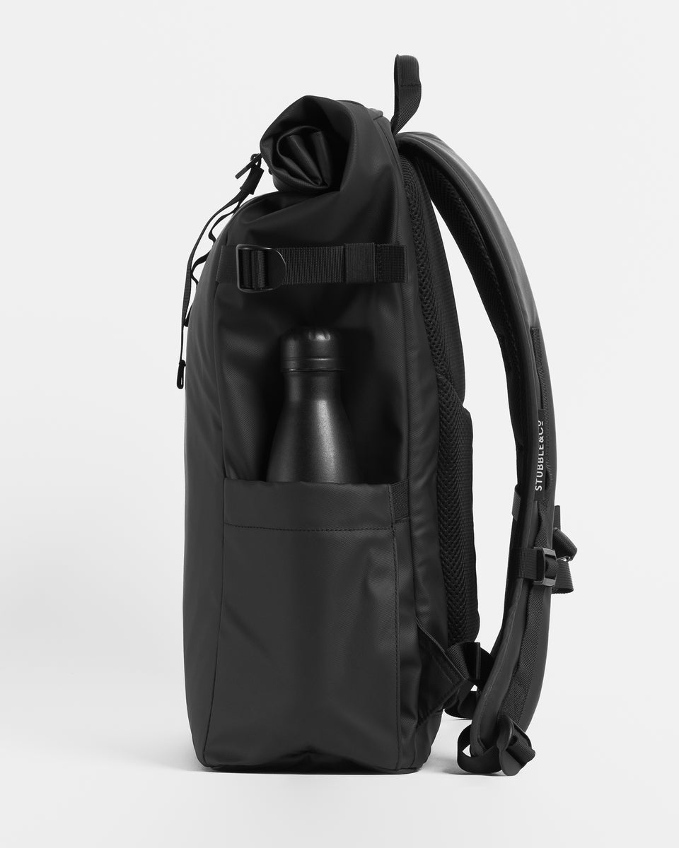 a studio shot of an all black roll top 20l showing the side bottle pocket