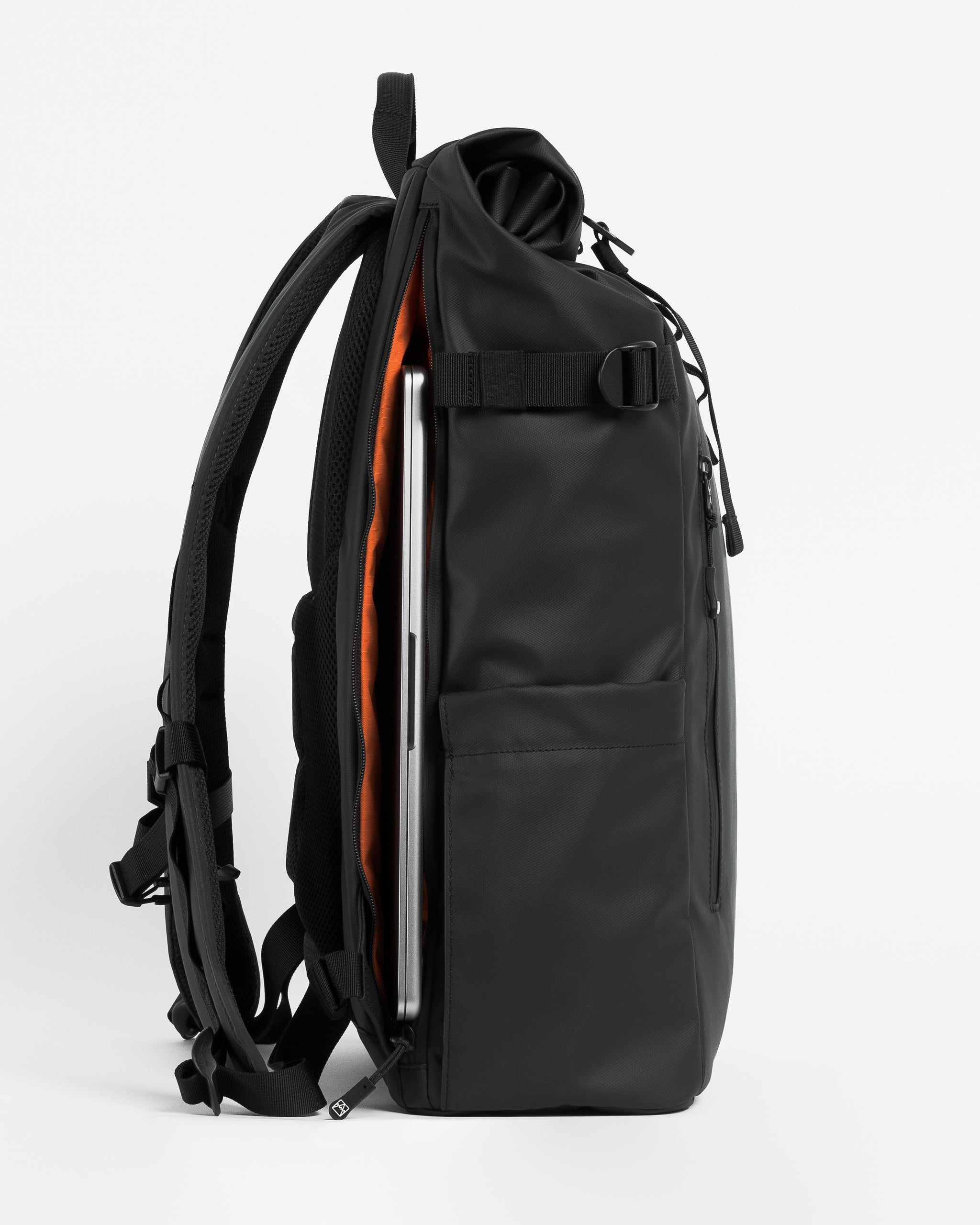 a studio shot of an All Black roll top 20l showing the laptop compartment