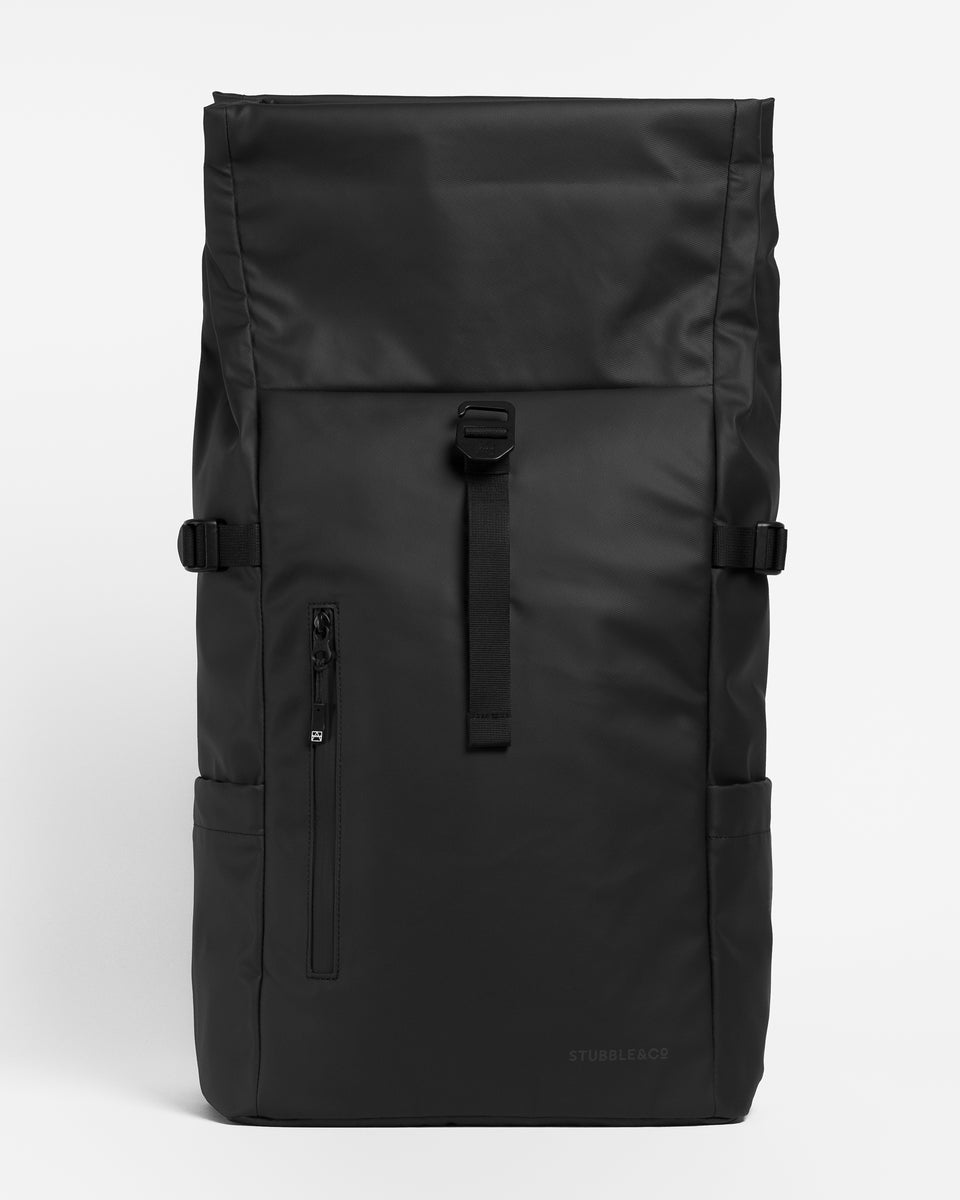a studio shot of an all black roll top 20l showing an unrolled backpack