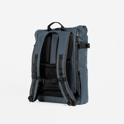 A studio shot of the back panel and adjustable chest strap on the Roll Top 15L in Tasmin Blue
