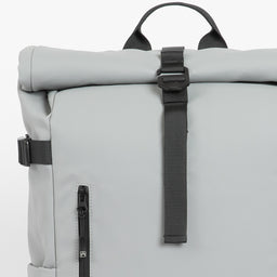 A studio shot of a close up of the roll and g-hook closure on a Roll Top 20L in Concrete