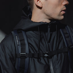 a close up on the adjustable chest straps on a Roll Top 20L in Midnight Blue