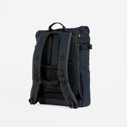 A studio shot of the back panel and adjustable chest strap on the Midnight Blue Roll Top 20L