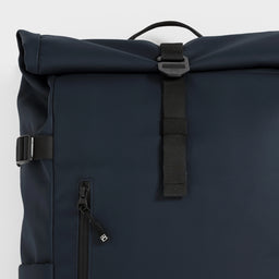 A studio shot of the roll and g-hook closure on the Roll Top 20L in Midnight Blue