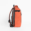 Side view of The Roll Top 20L backpack in Ember Orange with laptop compartment