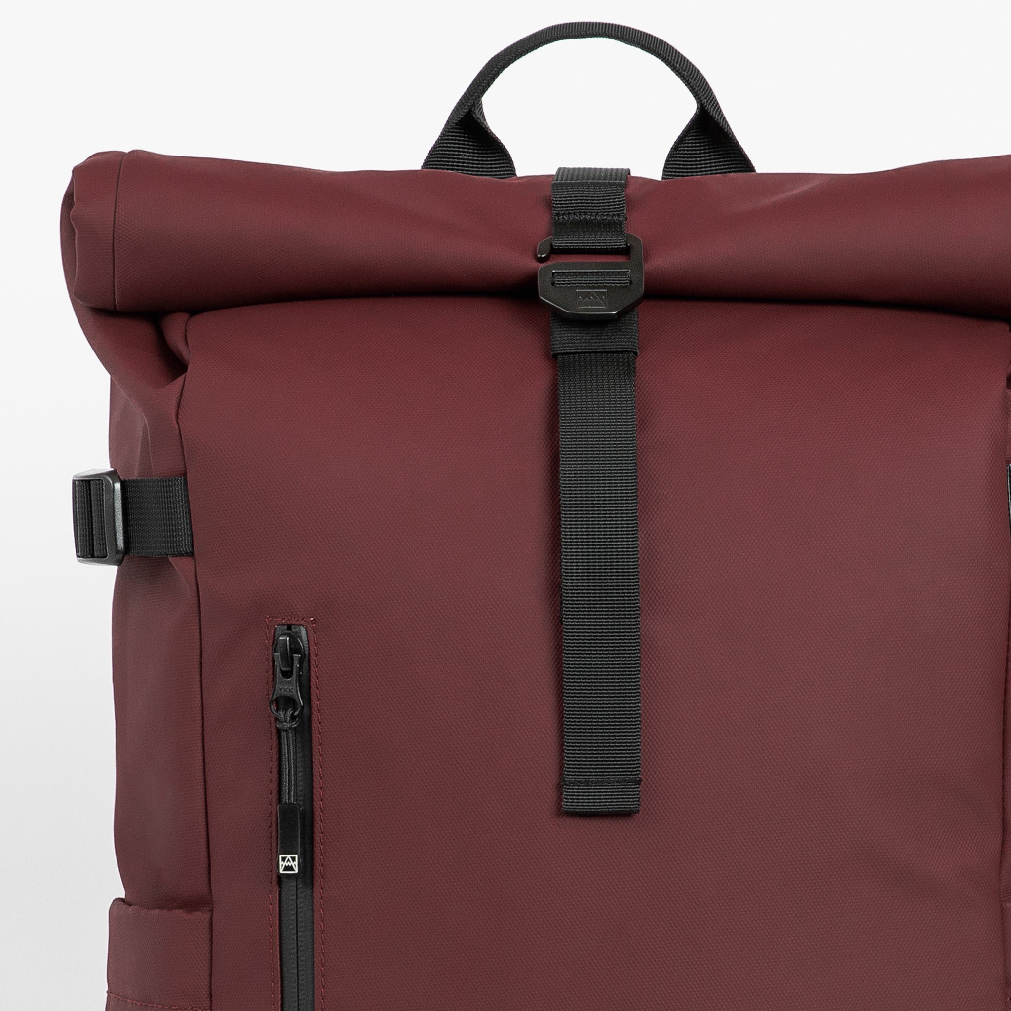 A studio shot of the close up roll and g-hook closure on the Garnet Red Roll Top 20L in Garnet Red