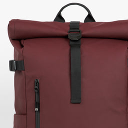 A studio shot of the close up roll and g-hook closure on the Garnet Red Roll Top 20L in Garnet Red
