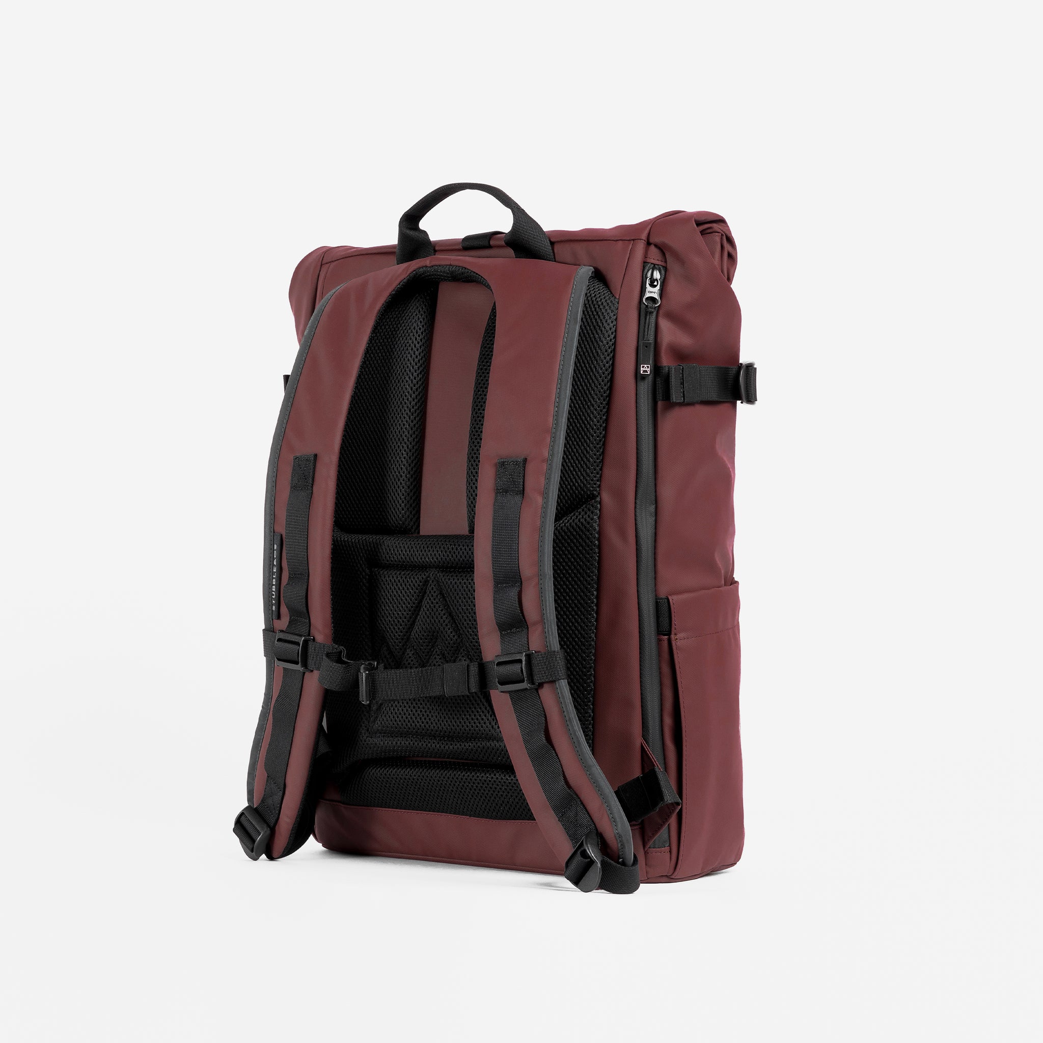 A studio shot of the Roll Top 20L back panel and adjustable chest strap in Garnet Red