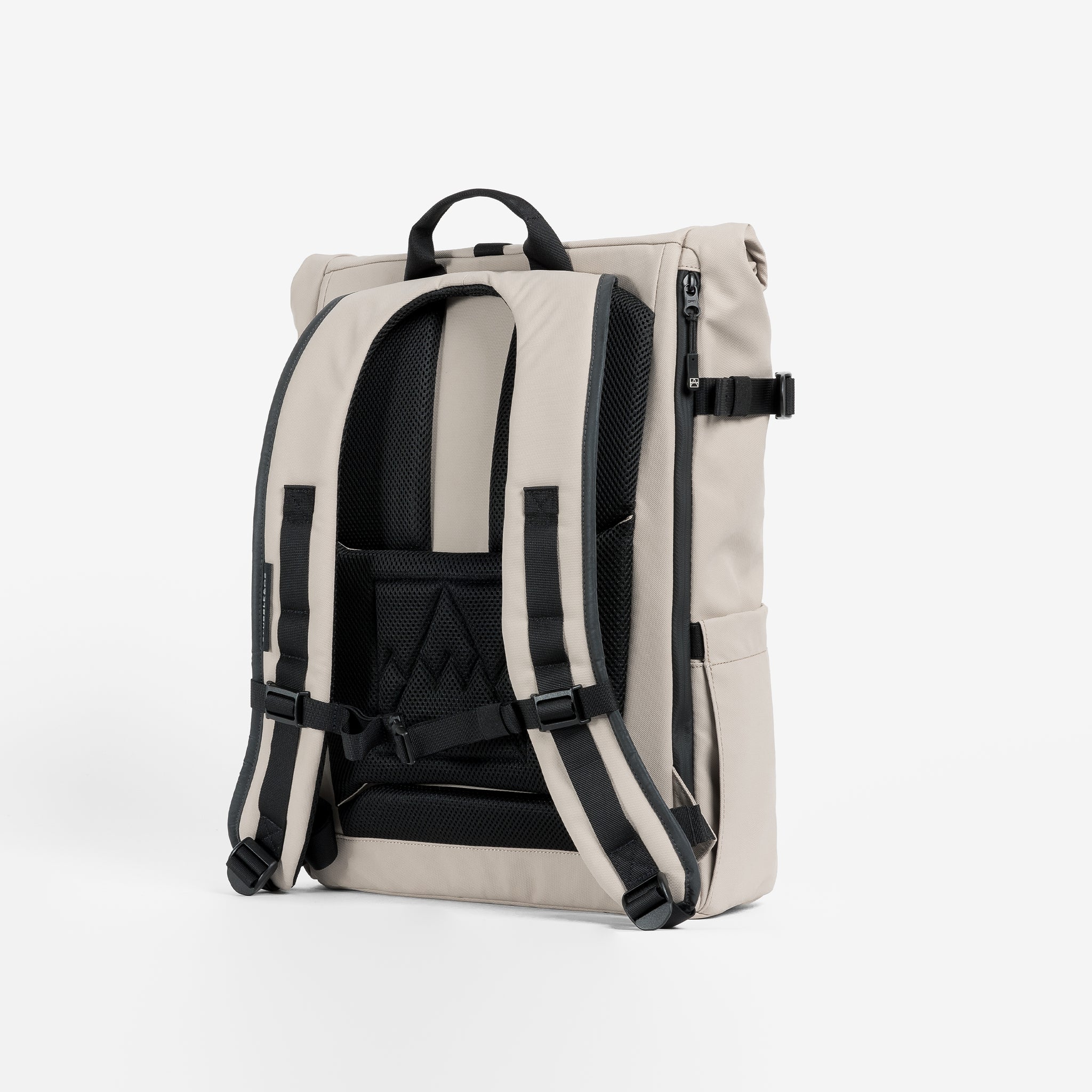 A studio shot of the back panel and adjustable chest strap  on the Roll Top 20L in Sand