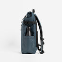 Side view of The Roll Top 20L backpack in Tasmin Blue