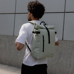 A man wearing a Roll Top 20L in Soft Mint on his back