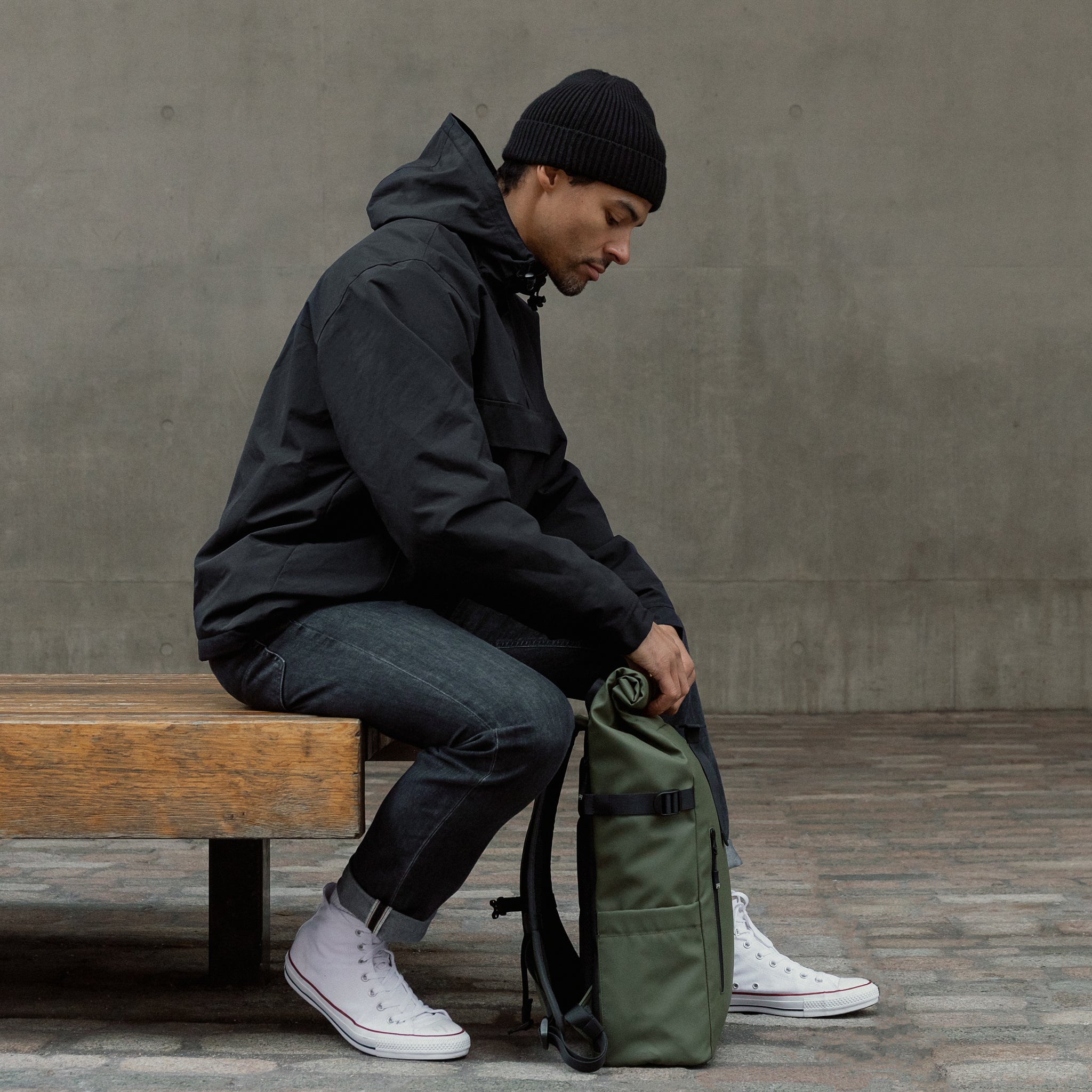 Man rolling The Roll Top in Urban Green