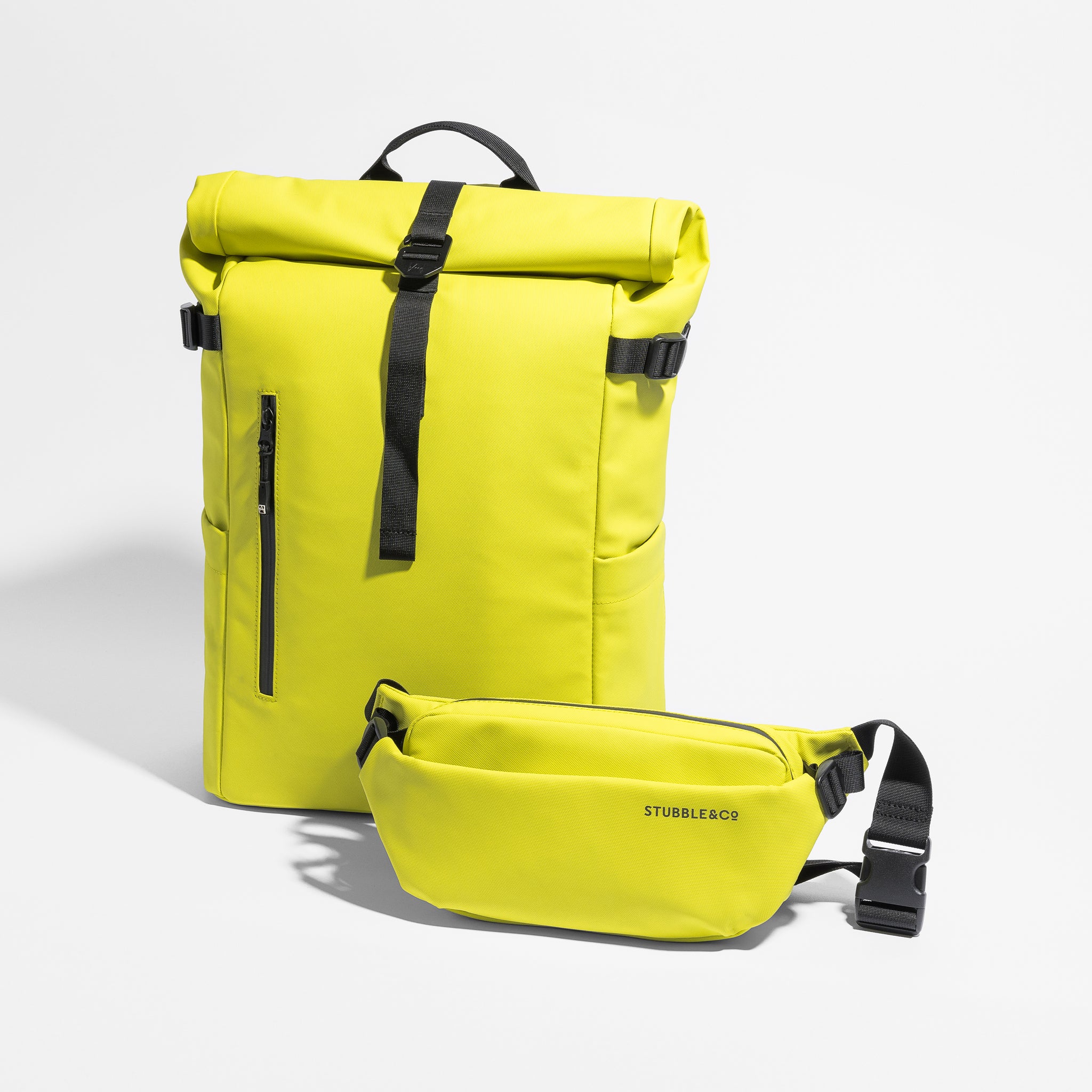 A studio shot of the Roll Top 20L and Crossbody in Volt
