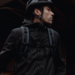 a man wearing a Roll Top 30L in Tasmin Blue on his back with the chest-straps done up