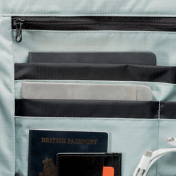 A  studio shot of the Roll Top 30l in Tasmin Blue showing the interior orange lining and organisation