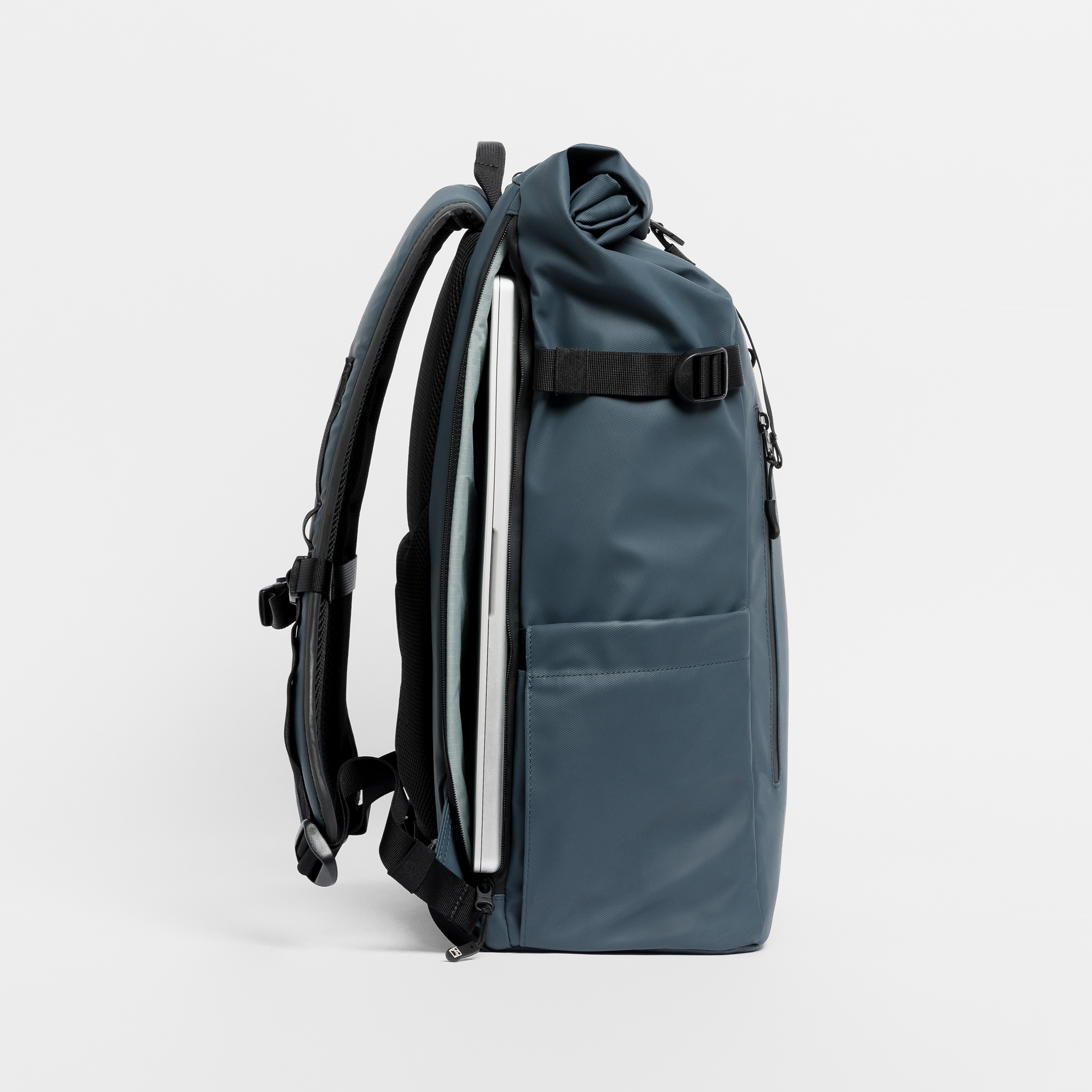 A  studio shot of the Roll Top 30l in Tasmin Blue showing the laptop compartment
