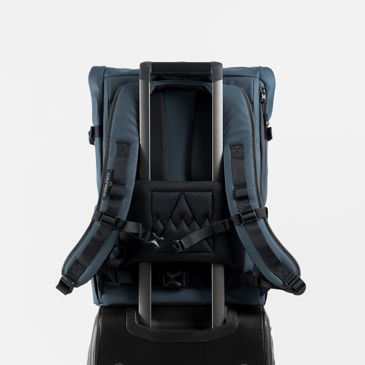 A  studio shot of the Roll Top 30l in Tasmin Blue showing luggage sleeve