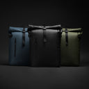 A picture of the Roll Top 30L backpacks in a studio in all 3 colours, black, Tasmin Blue and green