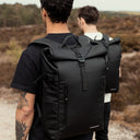 Man wearing Roll Top backpack in All Black