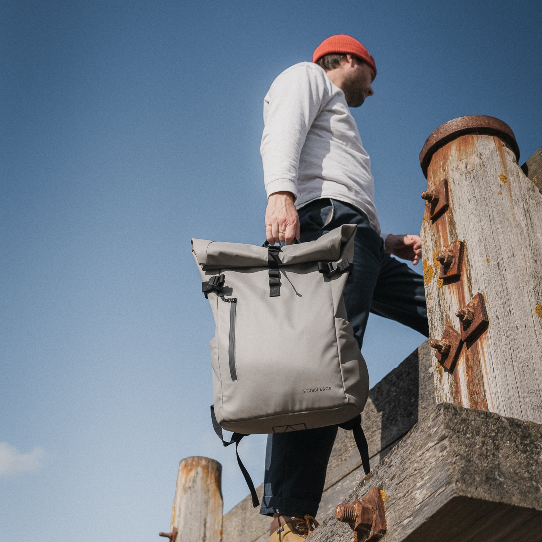 a man carrying a roll top 20l in concrete at his side - the travel project blog