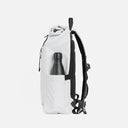 A studio shot of the bottle pocket on the Roll Top Mini backpack in Arctic White
