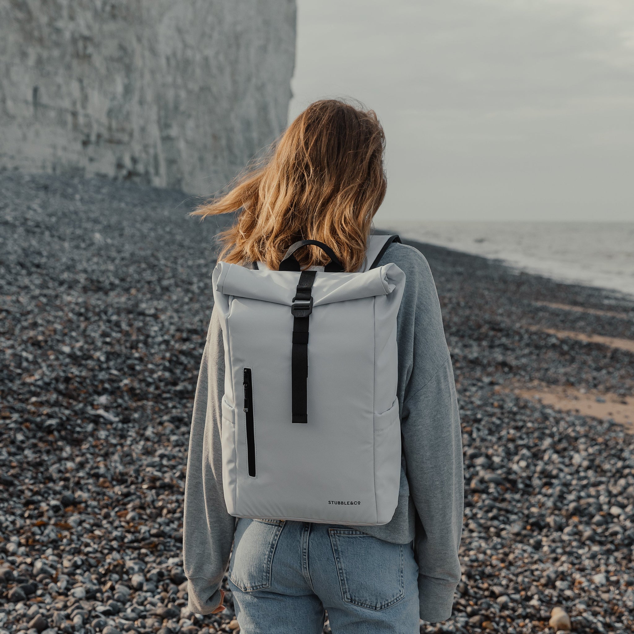 Women wearing Roll Top Mini backpack in Arctic White