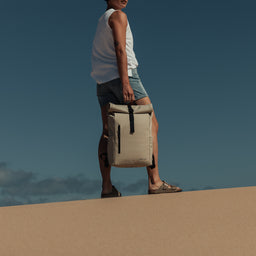 Women holding Roll Top Mini backpack in Sand