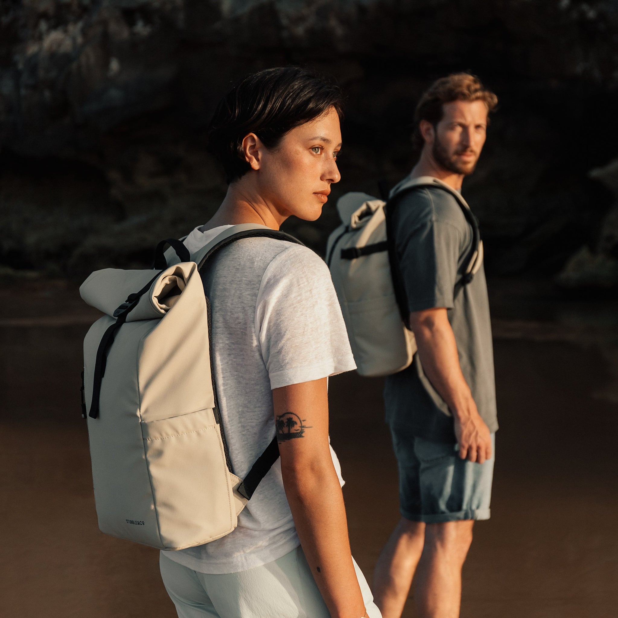 Women and man wearing Roll Top Mini backpack in Sand