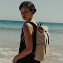 Women wearing Roll Top Mini backpack in Sand