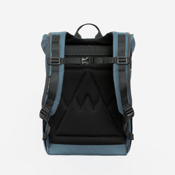 A studio shot of the back panel on a Roll Top Mini backpack in Tasmin Blue back
