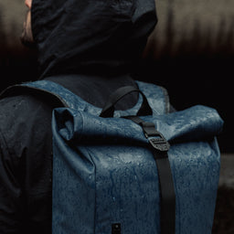 Roll Top Mini backpack in Tasmin Blue in the rain