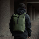Man wearing Roll Top Mini backpack in Urban Green
