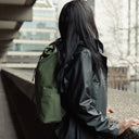 Women wearing Roll Top Mini backpack in Urban Green