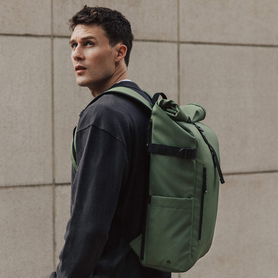 Man wearing Roll Top backpack in Urban Green