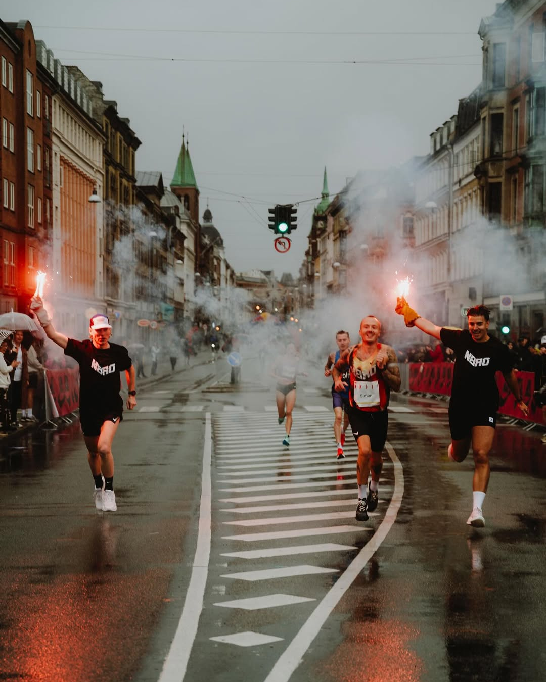 Runners holding flares during Copenhagen Marathon