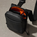 a close up of an All Black shoulder bag showing the interior pockets