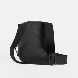 a studio shot of the back of an All Black shoulder bag